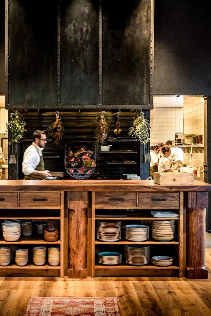 A kitchen with servers and chefs working