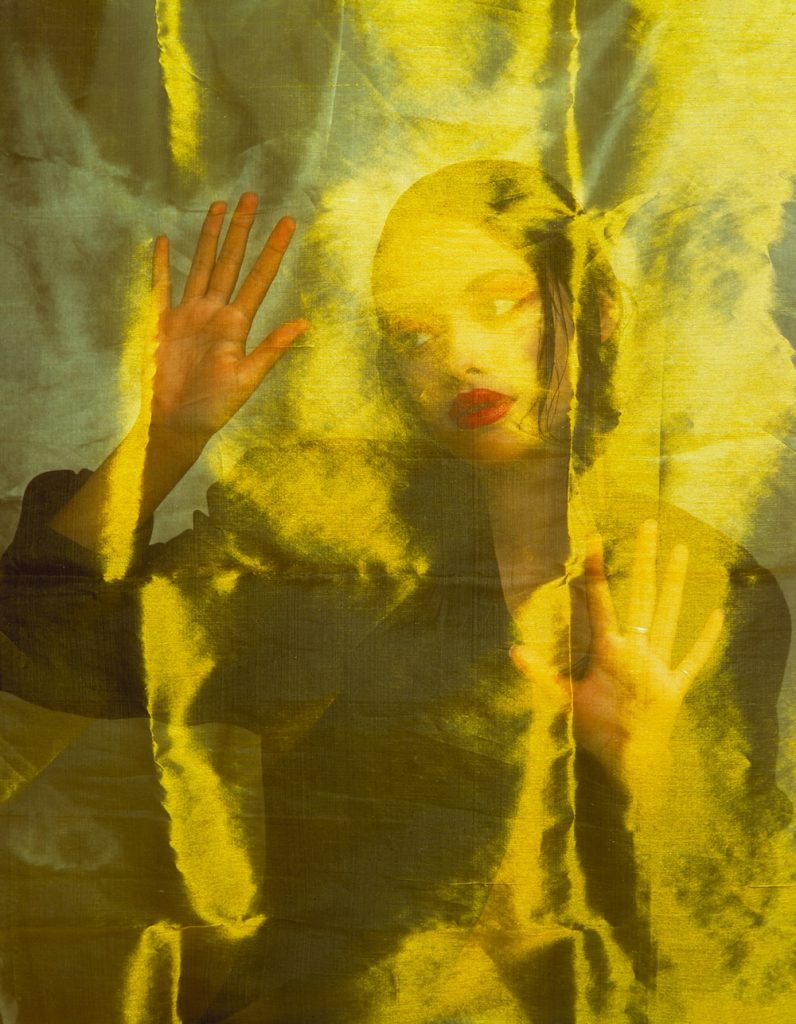 A woman posing for a photograph by Bret Lopez