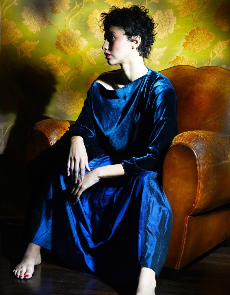 A woman posing for a photograph by Bret Lopez