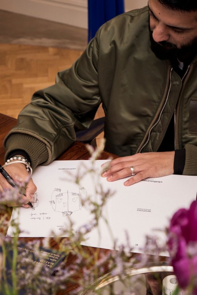 man designing clothes at Savile Row tailor