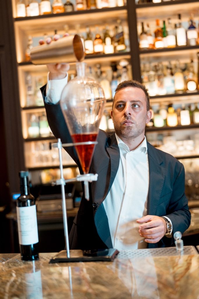 A server pouring a cocktail at Collegio alla querce, Auberge Collection