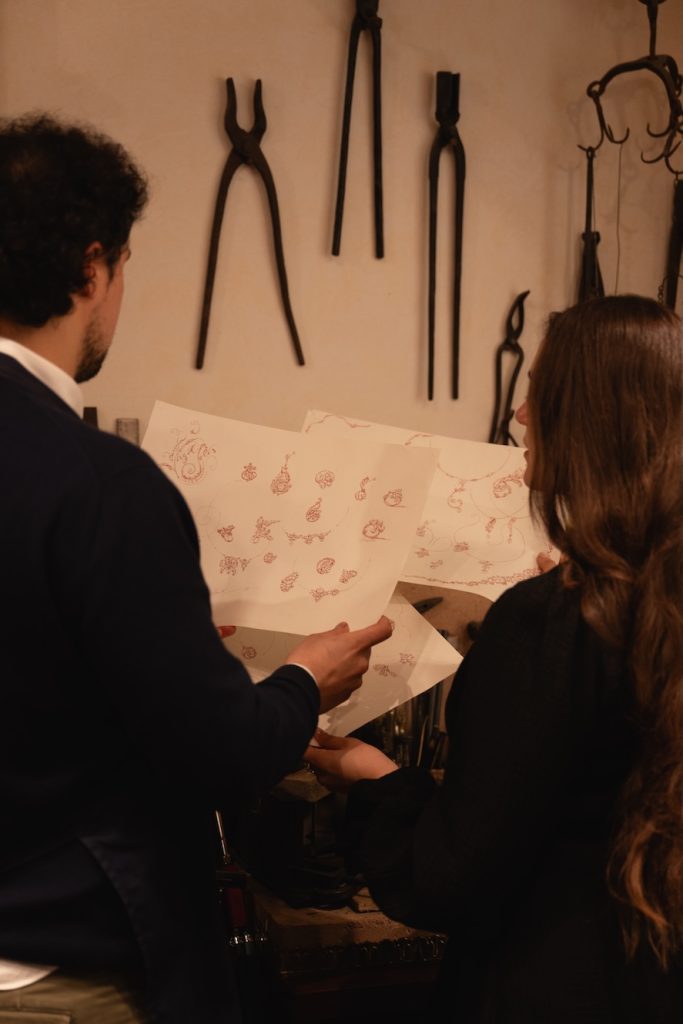 artisans inspecting designs