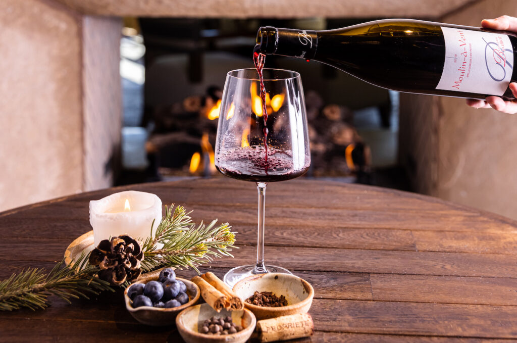 Red wine being poured into a glass on a table, celebrating the Santa Fe Wine and Chile Fiesta