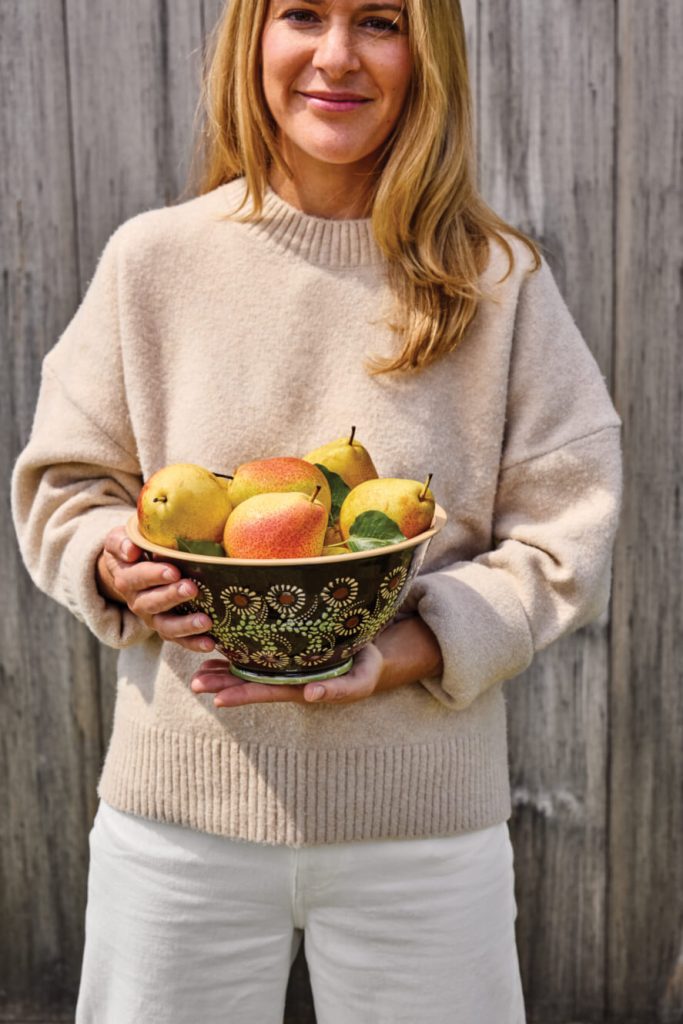 Woman holding bowl of fruit