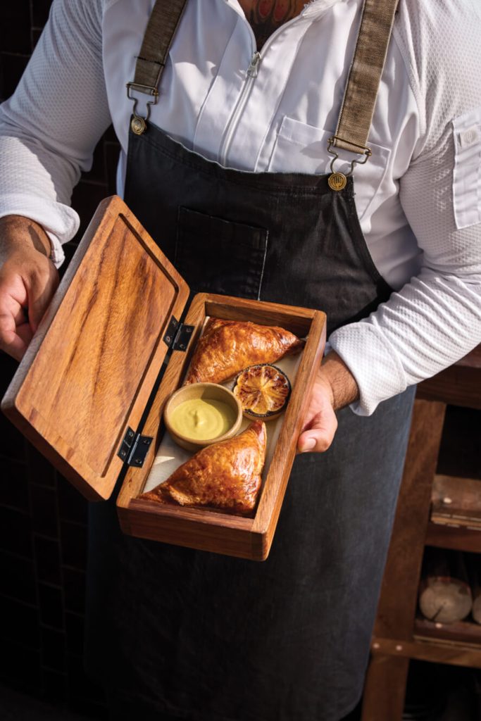 chef holding fresh empanadas