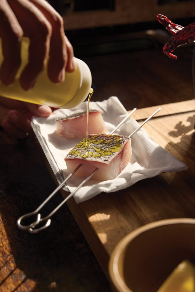 oil being poured onto fish