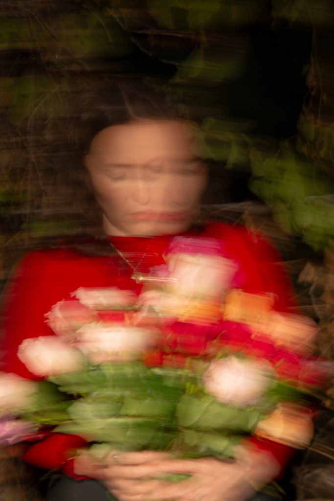 Rose Green holding flowers