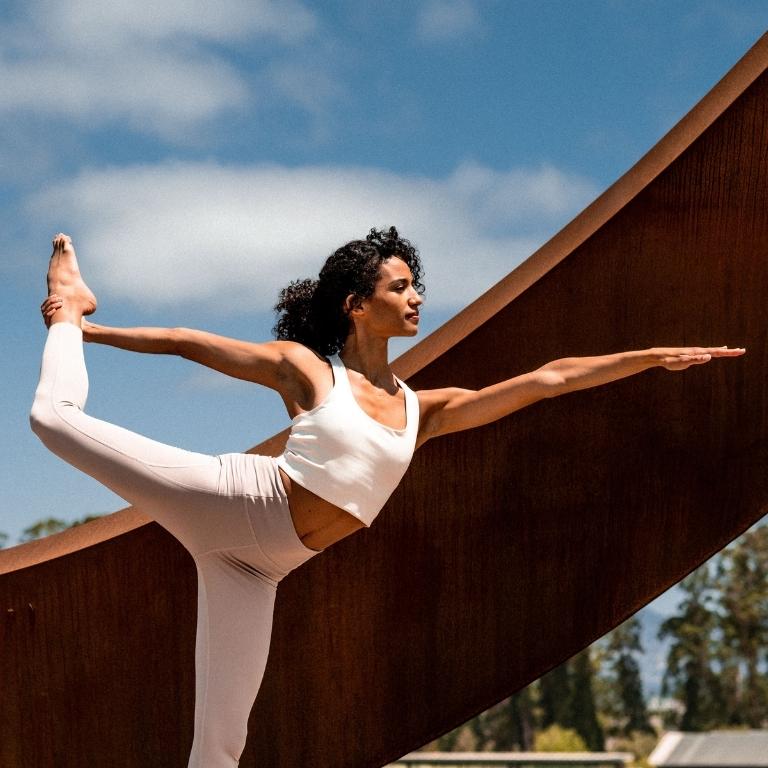Woman doing yoga by a sculpture at Stanly Ranch
